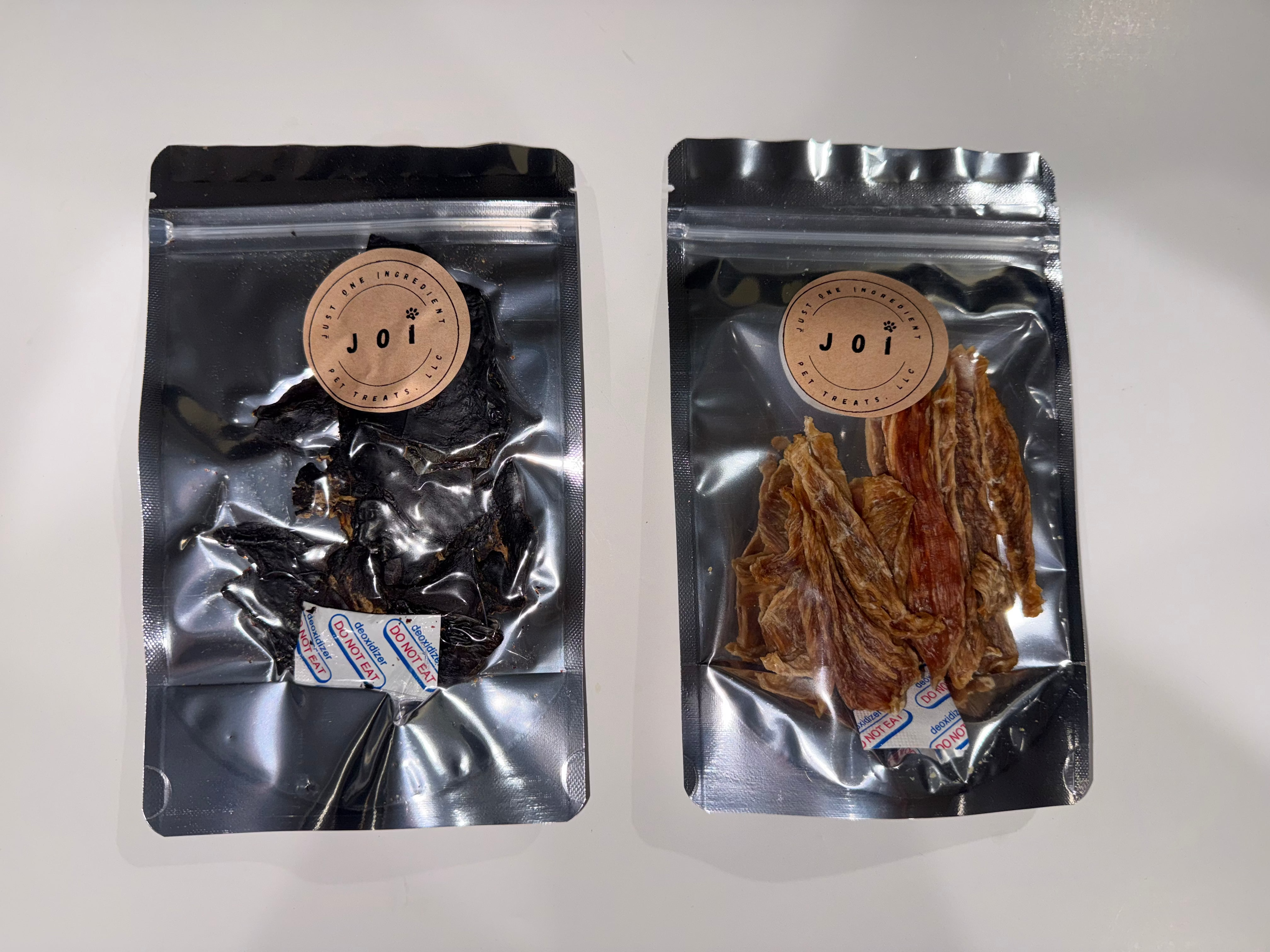 Two packages of treats with JOI label on a white background