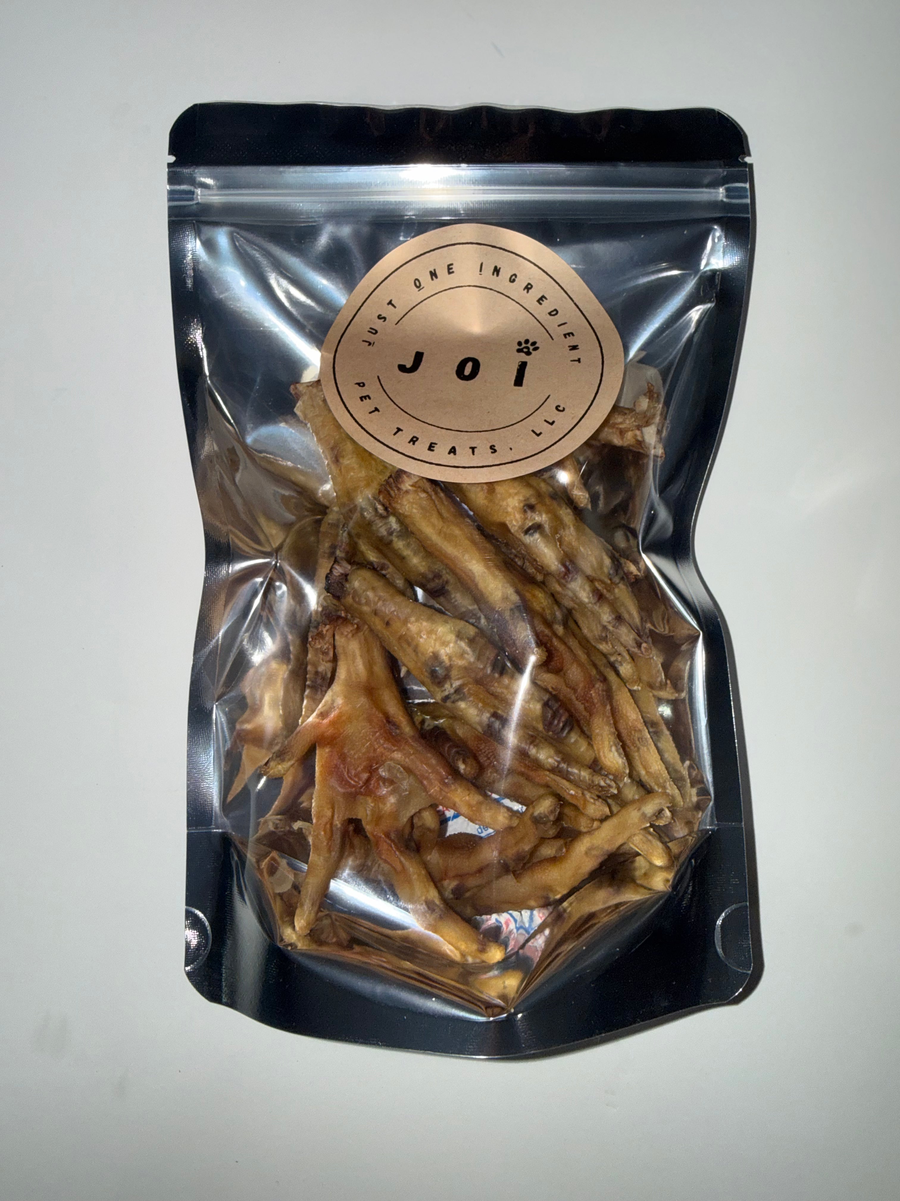 Packaged chicken feet treats with JOI label on a white background